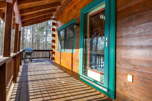 a porch of a log cabin with a door and windows at 2 Mi to Boat Ramp Log Cabin in New Hampshire in Washington