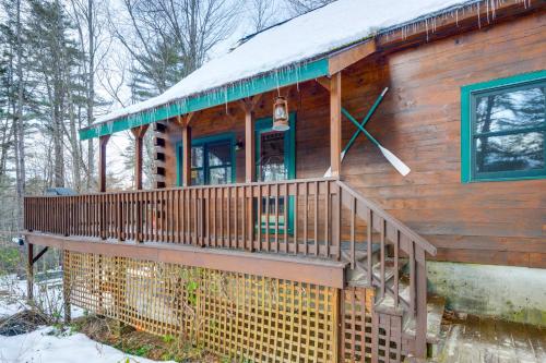a log cabin in the snow with a clock on it at 2 Mi to Boat Ramp Log Cabin in New Hampshire in Washington