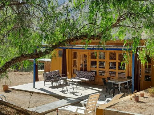 a house with a patio with tables and chairs at Casa Alma in Vicuña