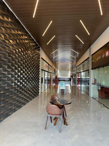 a empty shopping mall with a table and a chair at HOTEL NOVO CENTRO in Petrolina