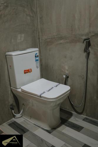 a toilet in a bathroom with a shower at D Plus Homestay Negombo in Negombo
