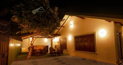 a house with lights on the side of it at night at D Plus Homestay Negombo in Negombo