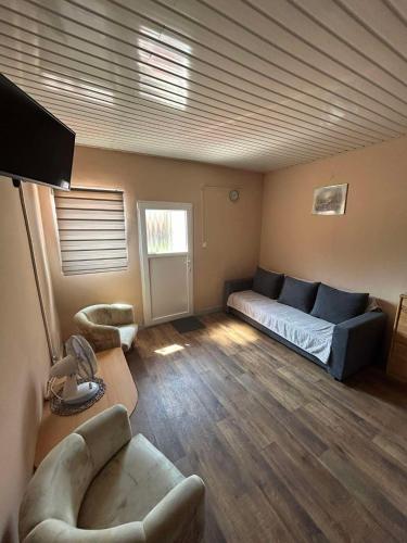 a living room with a bed and a couch at Boglárka Vendégház in Balatonboglár