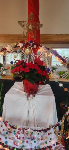 a table with a vase filled with christmas decorations at Hummingbird B&B in Gabriola