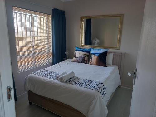 a bedroom with a large bed with a large mirror at 215 Sea View in Cape Town