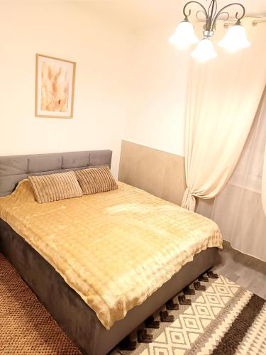 a bedroom with a bed with a yellow blanket at Family 2-Room Apartments Mürzzuschlag - Gazerstr 28 Top 2 in Mürzzuschlag