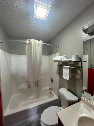 a bathroom with a tub and a toilet and a sink at Super 8 by Wyndham Blair in Blair
