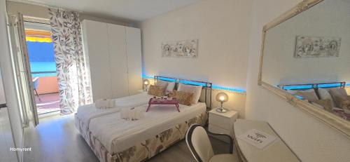 a bedroom with a large bed and a mirror at Residenza Lago di Lugano in Bissone