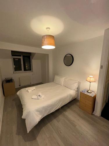 a bedroom with a white bed and a lamp at Northgate House in Chester
