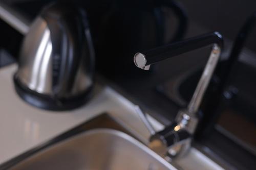 a close up of a kitchen sink with a faucet at Boutique Rooms in Belgrade