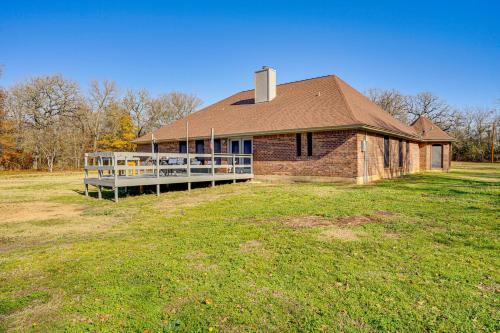 a large brick house in a field with a grass yard at Large Yard, Fire Pit and Games Grandview Haven! in Alvarado