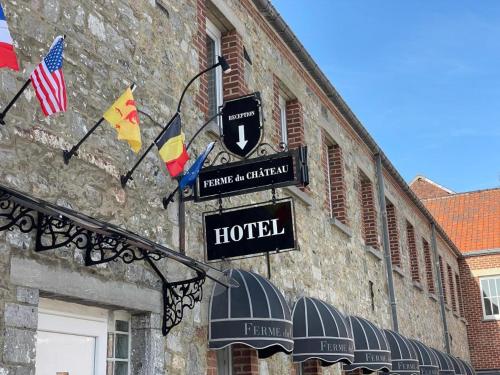 a hotel sign on the side of a building at La Ferme du Château - Luxury Suite in Fontaine-lʼÉvêque
