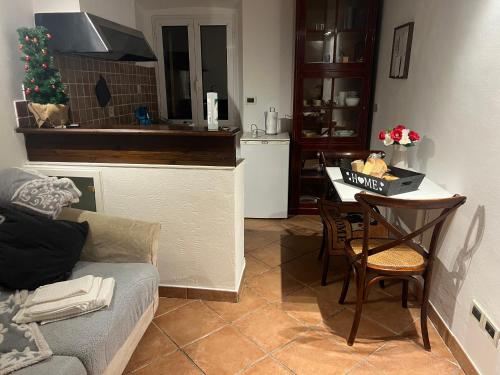 a living room with a couch and a kitchen with a christmas tree at CASA VACANZA Emma in Monfalcone