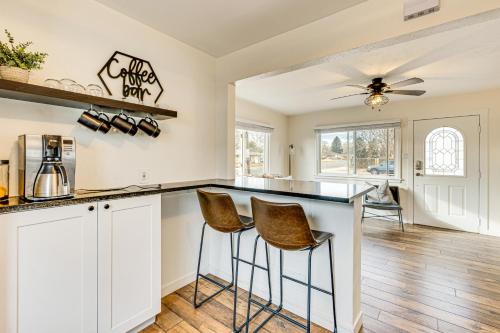 a kitchen with a counter and stools in a room at Dog-Friendly Home with Patio and Yard in Greeley in Greeley