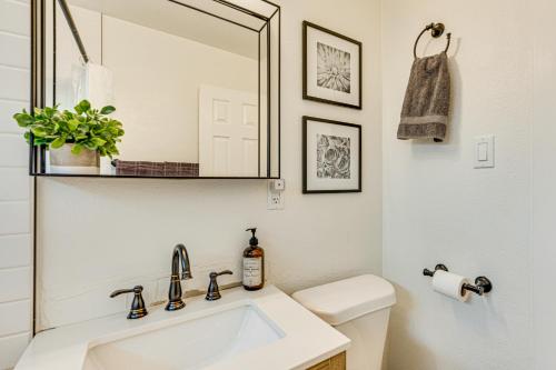 a white bathroom with a sink and a mirror at Dog-Friendly Home with Patio and Yard in Greeley in Greeley