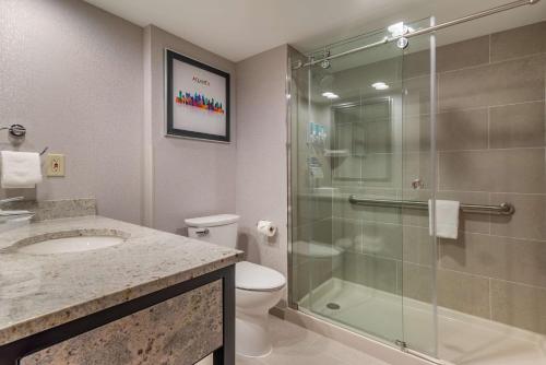 a bathroom with a shower and a sink and a toilet at Drury Inn & Suites Atlanta Airport in Atlanta