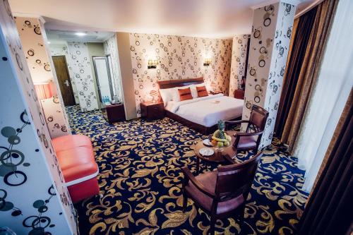 Кровать или кровати в номере Aria Hotel Chisinau