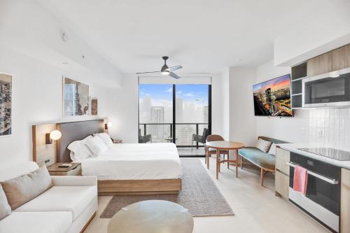 a bedroom with a bed and a living room at La Terrasse by VIAC - Luxury Bay View Studio with Balcony 29th Floor Miami in Miami