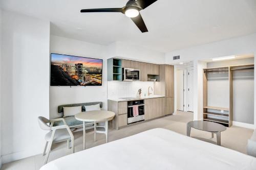 a bedroom with a bed and a table and chairs at La Terrasse by VIAC - Luxury Bay View Studio with Balcony 29th Floor Miami in Miami