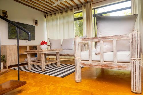 a bedroom with a wooden bed and a table at Serene 3 bed villa in the garden in Mombasa