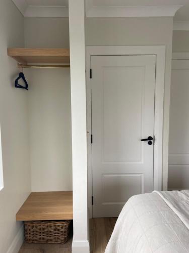a bedroom with a white door and a wooden shelf at Willow Lodge Cashel- Rock View-Sleeps 8 guests-Spacious- Cosy in Cashel
