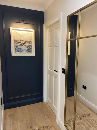 a hallway with a blue wall and a glass door at Willow Lodge Cashel- Rock View-Sleeps 8 guests-Spacious- Cosy in Cashel