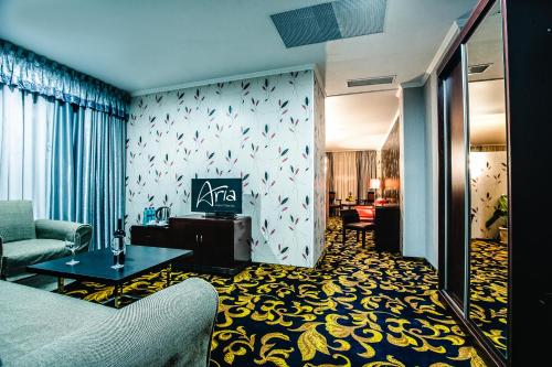 a living room with a couch and a table at Aria Hotel Chisinau in Chişinău