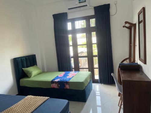 a small room with two beds and a window at Transit Terminal at colombo airport in Katunayake