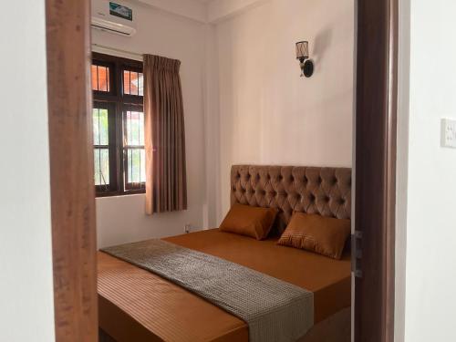 a small bed in a room with a window at Transit Terminal at colombo airport in Katunayake