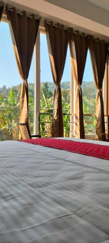 a view of a bed in a room with a window at Chill Breeze Paradise in Yelagiri
