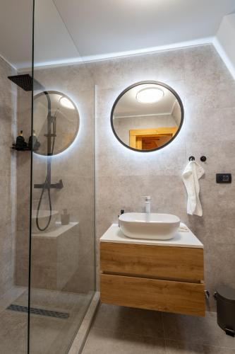 a bathroom with a sink and a mirror at A villa in Marija Trošt