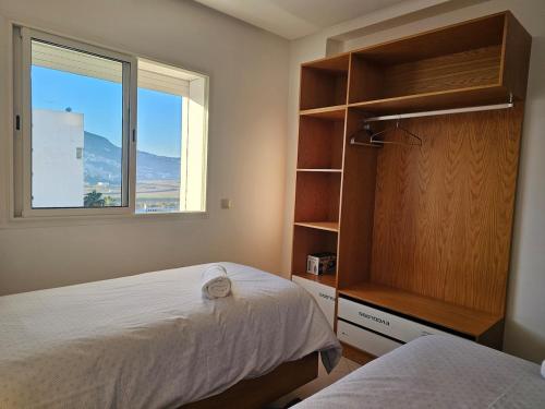 a bedroom with two beds and a window at La Esmeralda in Tetouan