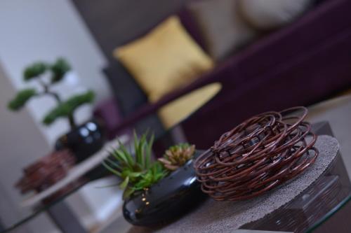a table with a vase with plants on it at Boutique Rooms in Belgrade