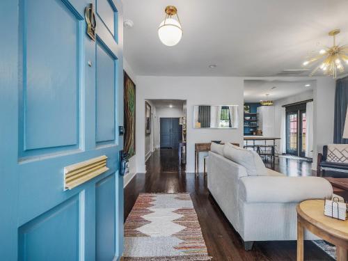 a living room with a blue door and a couch at Brooklyn House, Downtown Wilmington in Wilmington