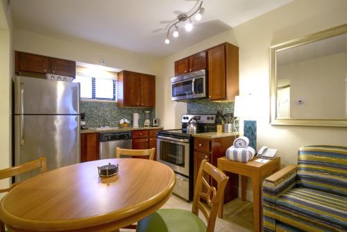 a kitchen with a wooden table and a dining room at La Costa Beach Club in Pompano Beach