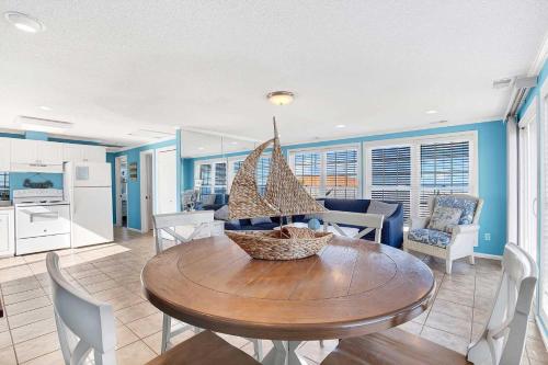a kitchen and dining room with a wooden table and chairs at Ocean front Rental 101-3 in Tybee Island