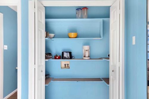 a pantry with blue walls and shelves at Ocean front Rental 101-3 in Tybee Island