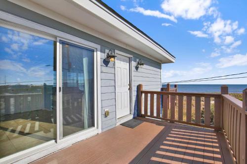 a house with a balcony with a view of the ocean at Ocean front Rental 101-3 in Tybee Island