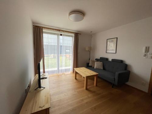 a living room with a couch and a table at Chata Smrčka in Železná Ruda
