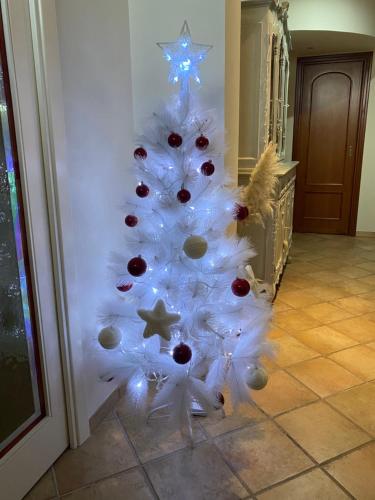 a white christmas tree with decorations on it at Rhome country lodge in La Massimina-Casal Lumbroso