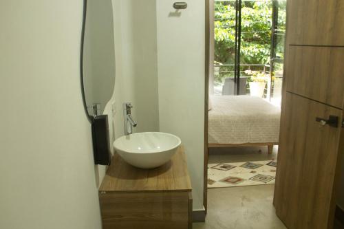 a bathroom with a bowl sink on a wooden counter at Norte Cali - Bosque Living -202 in Cali