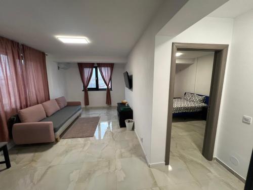 a living room with a couch and a bed at Everest 33 Ap 4 in Bucharest