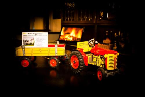 a toy dump truck with a trailer in front of a fireplace at Hotel Bigger Hof - Wirtshaus Platzhirsch am Jahnplatz in Olsberg