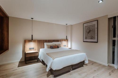 a bedroom with a large white bed in a room at 1616 Hotel in Medellín