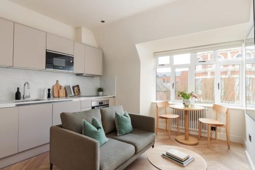a living room with a couch and a table at FiveM West Hampstead - North in London