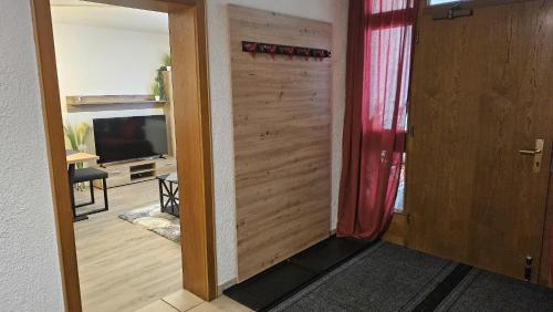a door leading to a living room with a television at Haus Carmen Kleboth in Gaschurn