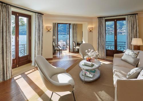 a living room with a couch and chairs and windows at Mandarin Oriental, Lago di Como in Blevio