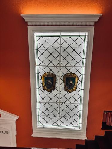 a stained glass window in a room with an orange wall at Palacio Pampinot in Hondarribia