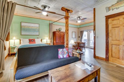a bedroom with a bed and a couch and a table at Walk to White River Cozy Studio, Driftys Hideaway in Cotter