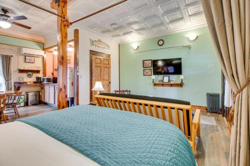 a bedroom with a bed with a wooden head board at Walk to White River Cozy Studio, Driftys Hideaway in Cotter